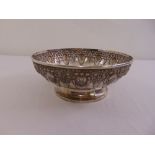 A continental white metal punch bowl, chased with a band of scrolls and stylised flowers, stamped
