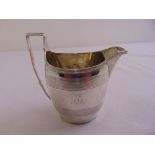 George III silver cream jug, shaped oval with ribbed bands and angled handle, London 1799