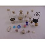 A quantity of scent bottles and dressing table pieces to include a watch stand, a silver mounted