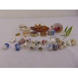 A quantity of collectables to include snuffboxes, paperweight, a Swarovski figurine and thimbles