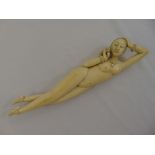 A late 19th century Oriental ivory figurine of a medicine lady