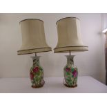 A pair of Chinese porcelain and gilt metal table lamps with silk shades