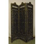 A Moroccan scroll pierced three panel wooden screen decorated with white metal mounts and coloured