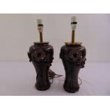 A pair of bronzed Art Nouveau style lamp bases with applied floral decorations