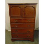 A rectangular mahogany chest with four drawers and hinged doors to the top, on four bracket feet