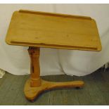 A Victorian pine overbed desk on tubular column and shaped trefoil base