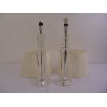A pair of Art Deco style hexagonal glass table lamps with silk shades on raised circular bases