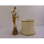 A gilt metal and onyx table lamp in the form of a classical figurine on raised cylindrical base