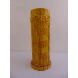 A Burmantoffs cylindrical umbrella stand, yellow ground with stylised leaves and geometric forms,