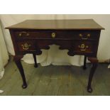 An 18th century rectangular oak lowboy desk, one long drawer over two short, brass swing handles