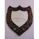 A Chinese shield shaped wall mirror, the pierced hardwood frame carved with dragons, mirror A/F