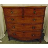 A 19th century rectangular bow fronted chest of drawers with brass swing handles on four scroll