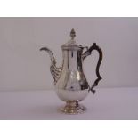 A George III Irish silver coffee pot, the pear shaped body with leaf capped fluted scrolling