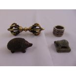 A Chinese white metal archers ring, a figurine of a hedgehog, a seal with turtle figurine and a