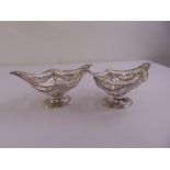 A pair of late Victorian oval bar pierced silver sweetmeat dishes on raised oval bases, London