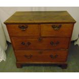 A rectangular pine chest of drawers with brass swing handles on four bracket feet
