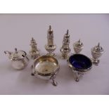 A George II silver salt by David Mowden 1750, another salt, a mustard pot and five pepperettes,