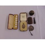 A quantity of collectables to include two silver medals, dress buttons, a seal and a leather vesta