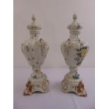 A pair of Italian Majolica ceramic vases on detachable stands and with pull off covers decorated