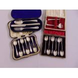 A cased set of six silver teaspoons, a cased Christening set, a cased pusher and spoon and a cased