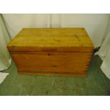 A rectangular pine blanket box with hinged cover