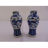 A pair of 19th century Chinese blue and white baluster vases decorated with dragons and bats