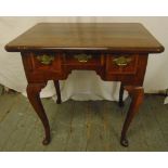 A Georgian rectangular walnut lowboy with three cross banded drawers, four cabriole legs with pad