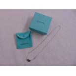 A Tiffany bean silver pendant and chain in original packaging