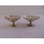 A pair of hallmarked silver circular bonbon dishes on raised circular bases