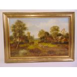 A framed oil on board of cottages by a river, indistinctly signed and dated 1913, 39 x 60cm