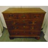 A 19th century rectangular oak chest of drawers with brass swing handles on four bracket feet