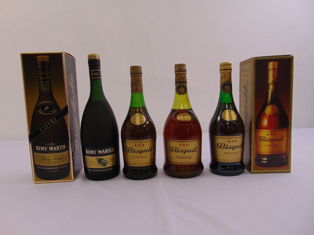 Four bottles of Cognac to include Remy Martin and Bisquit