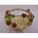 A Majolica style lattice work ceramic fruit basket decorated with applied fruit and leaves