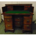 An early 18th century Queen Anne rectangular walnut kneehole secretaire desk, half hinged top and