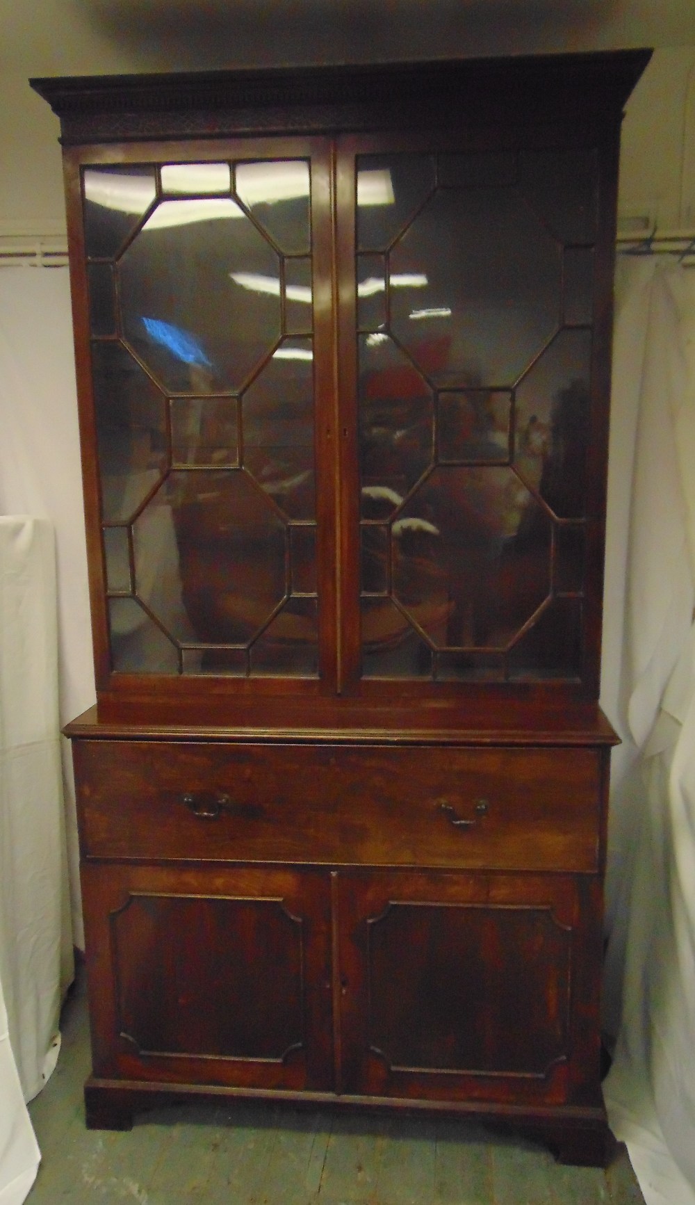 A 19th century rectangular mahogany secretaire bookcase, with hinged glazed doors above four drawers