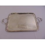 A continental silver plated tray, rounded rectangular with reed and tie border and two pierced side