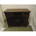An Oriental rectangular hardwood sideboard with drawers and cupboards on four bracket feet