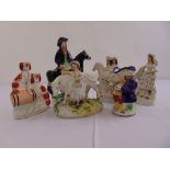 A quantity of Staffordshire figurines to include spaniels, figures on horseback, a milkmaid and a