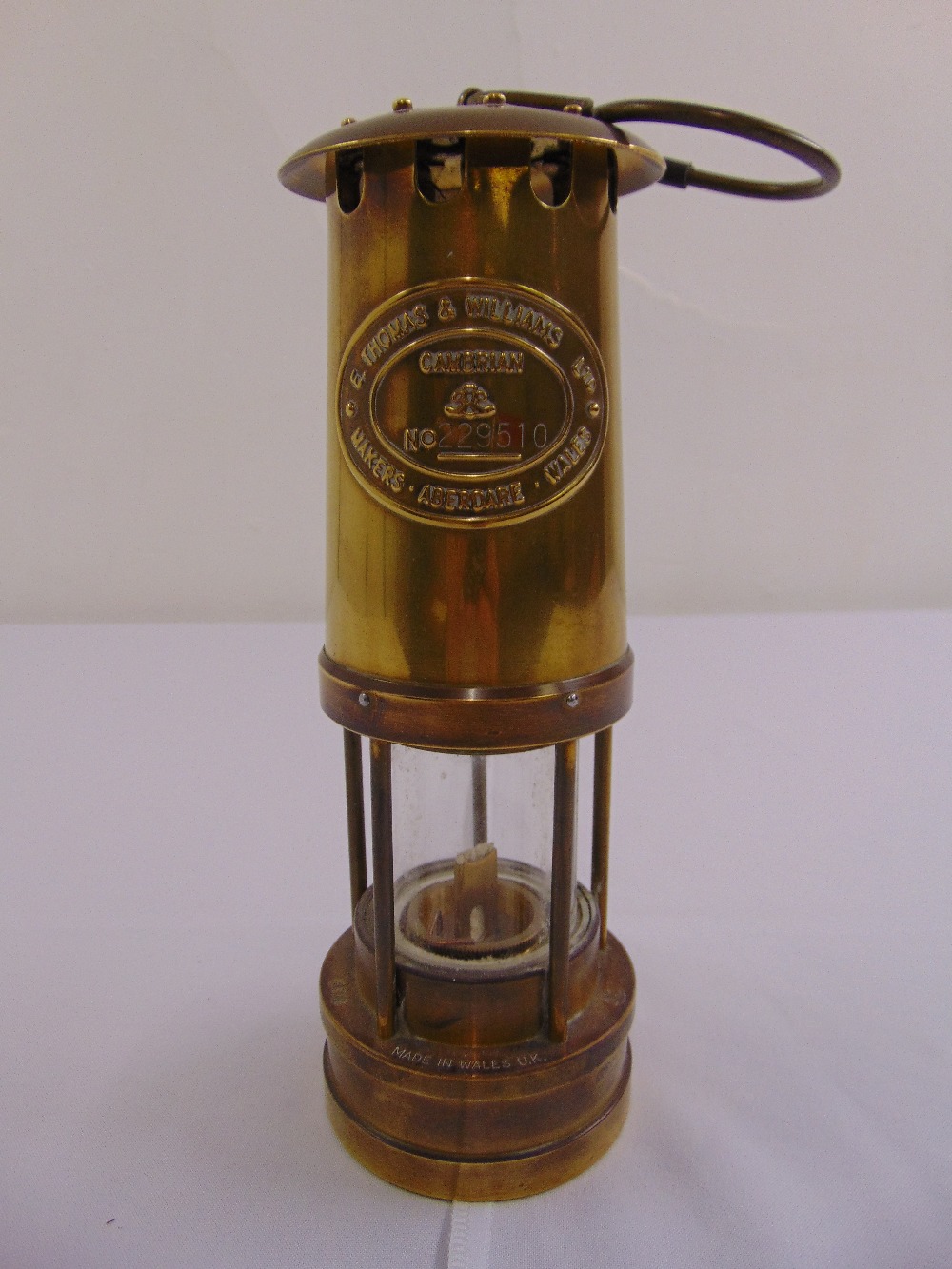 A miners brass Davy lamp by E. Thomas and Williams Ltd, no 229510