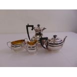 A silver four piece tea and coffee set, rounded rectangular on rimmed feet, Birmingham 1949 by
