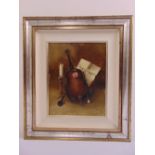 A framed oil on canvas still life of a cello, indistinctly signed bottom right, 29.5 x 23cm