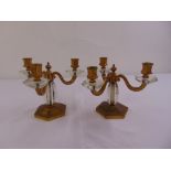 A pair of three light gilt metal and glass table candelabra on hexagonal bases