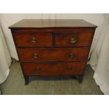 A Georgian rectangular mahogany chest of drawers, with oval brass swing handles on four bracket