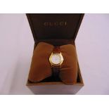 A Gucci gold plated ladies wristwatch with leather strap in original fitted case