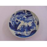 A Chinese blue and white charger decorated with figures in a stylised landscape