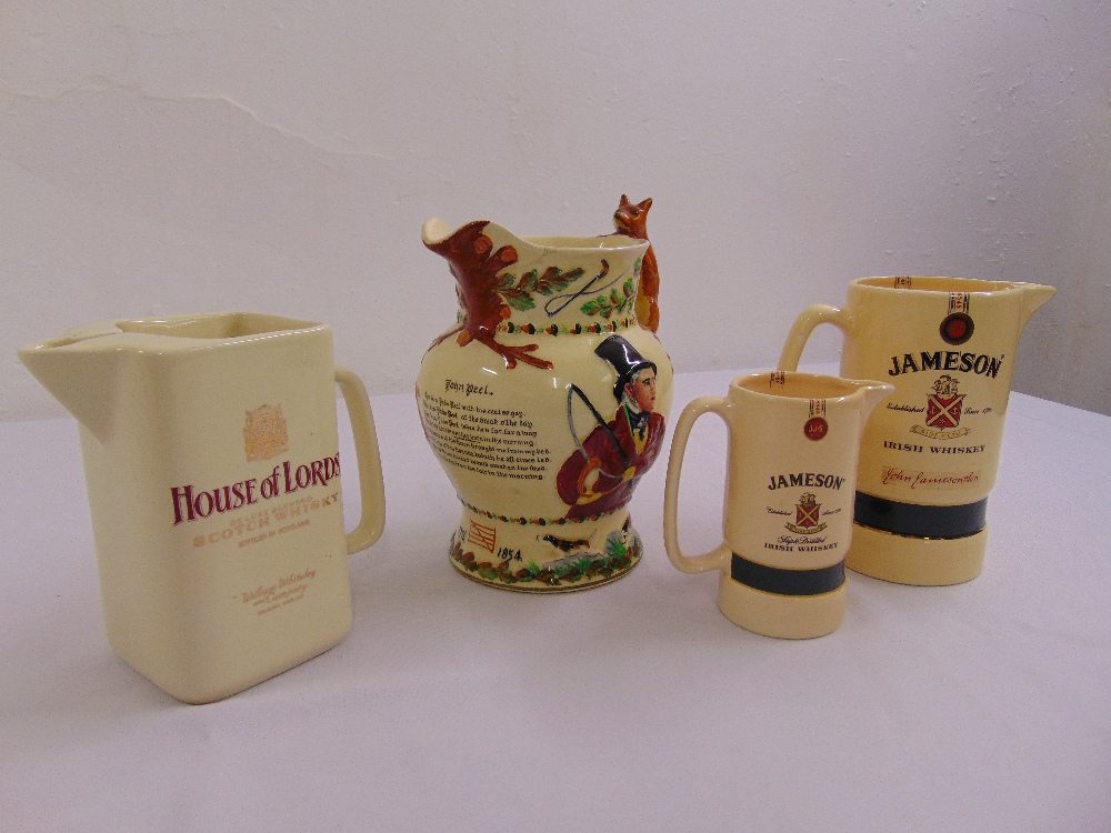 A quantity of advertising water jugs and a John Peel ceramic musical hunting jug with fox handle (