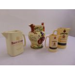 A quantity of advertising water jugs and a John Peel ceramic musical hunting jug with fox handle (