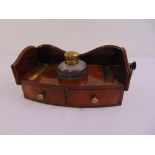 A Regency mahogany shaped rectangular inkstand with two drawers and scroll carved gallery to include