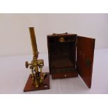 J.H. Steward brass microscope in fitted wooden case, to include twenty-five prepared slides