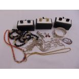 A quantity of silver and costume jewellery to include necklaces, brooches and bangles